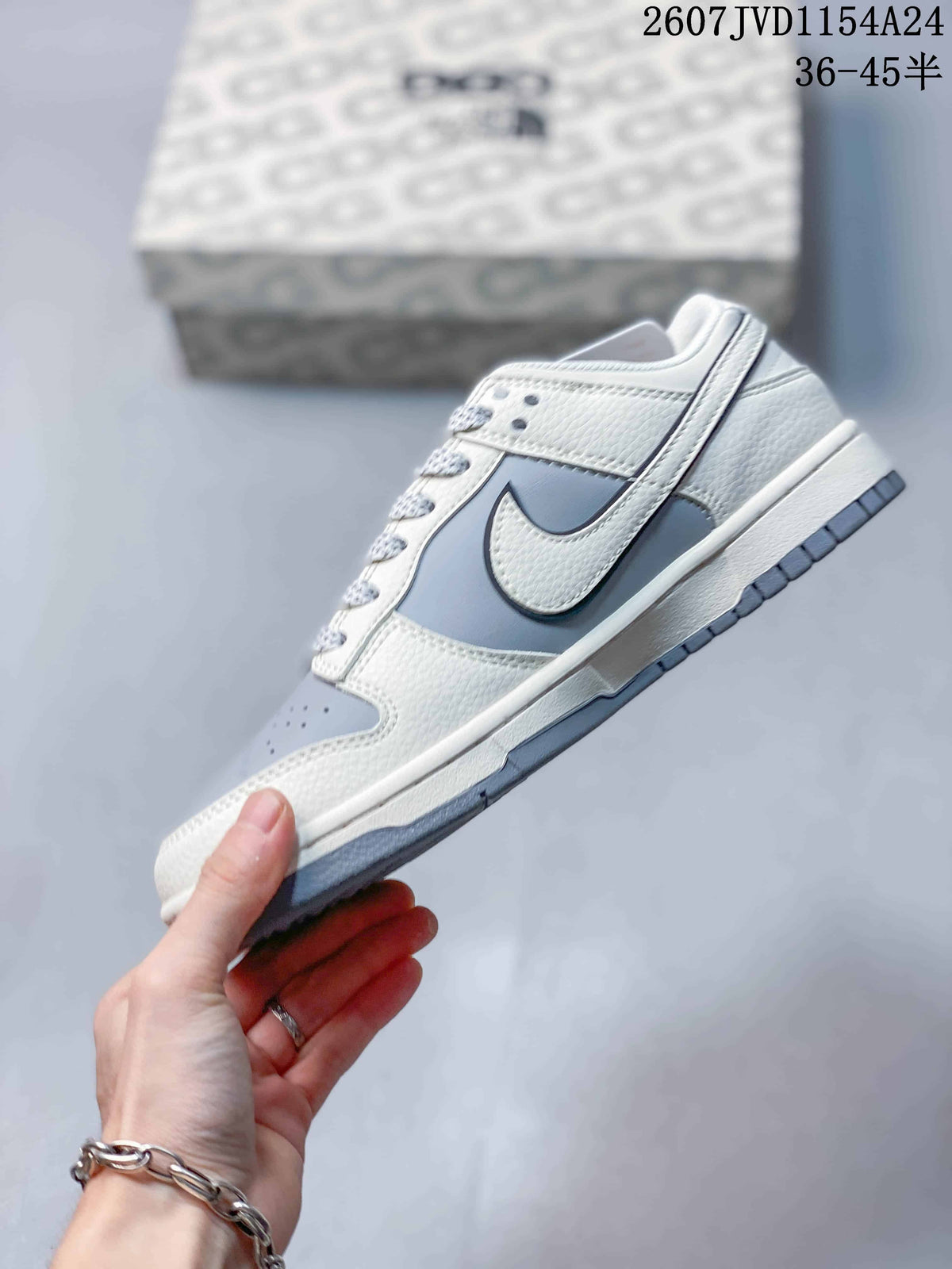 Side profile showing the grey and white upper, contrasting Swoosh, white midsole and grey outsole.