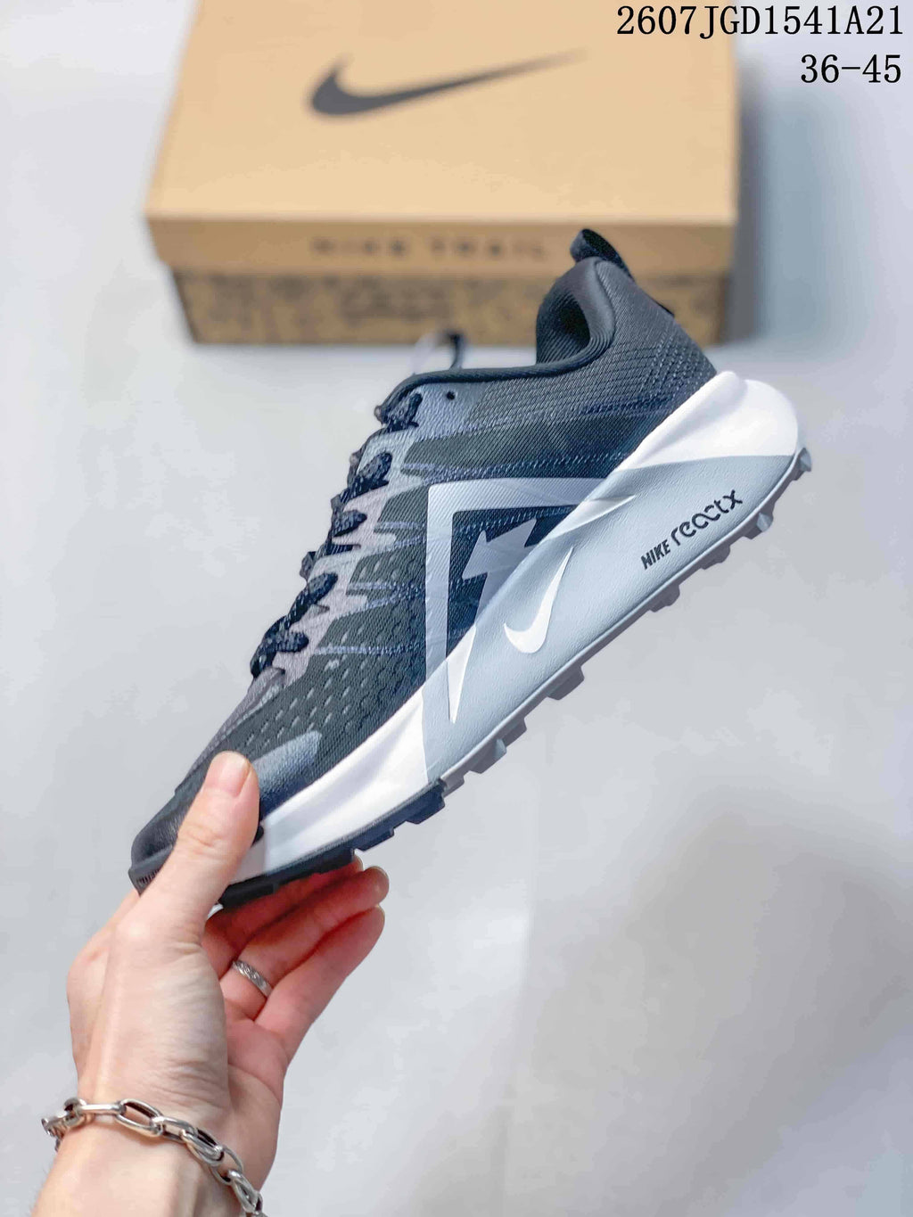 Side profile of the Nike Wildhorse 10 sneaker showing the white Swoosh, ReactX-marked midsole, and textured outsole.