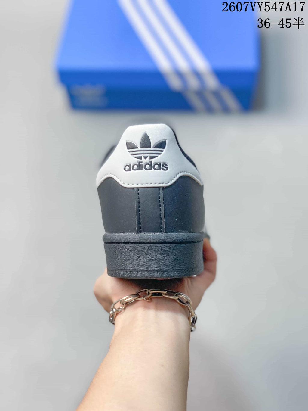 Rear view of the black sneaker showing the white heel detail and Adidas trefoil branding.