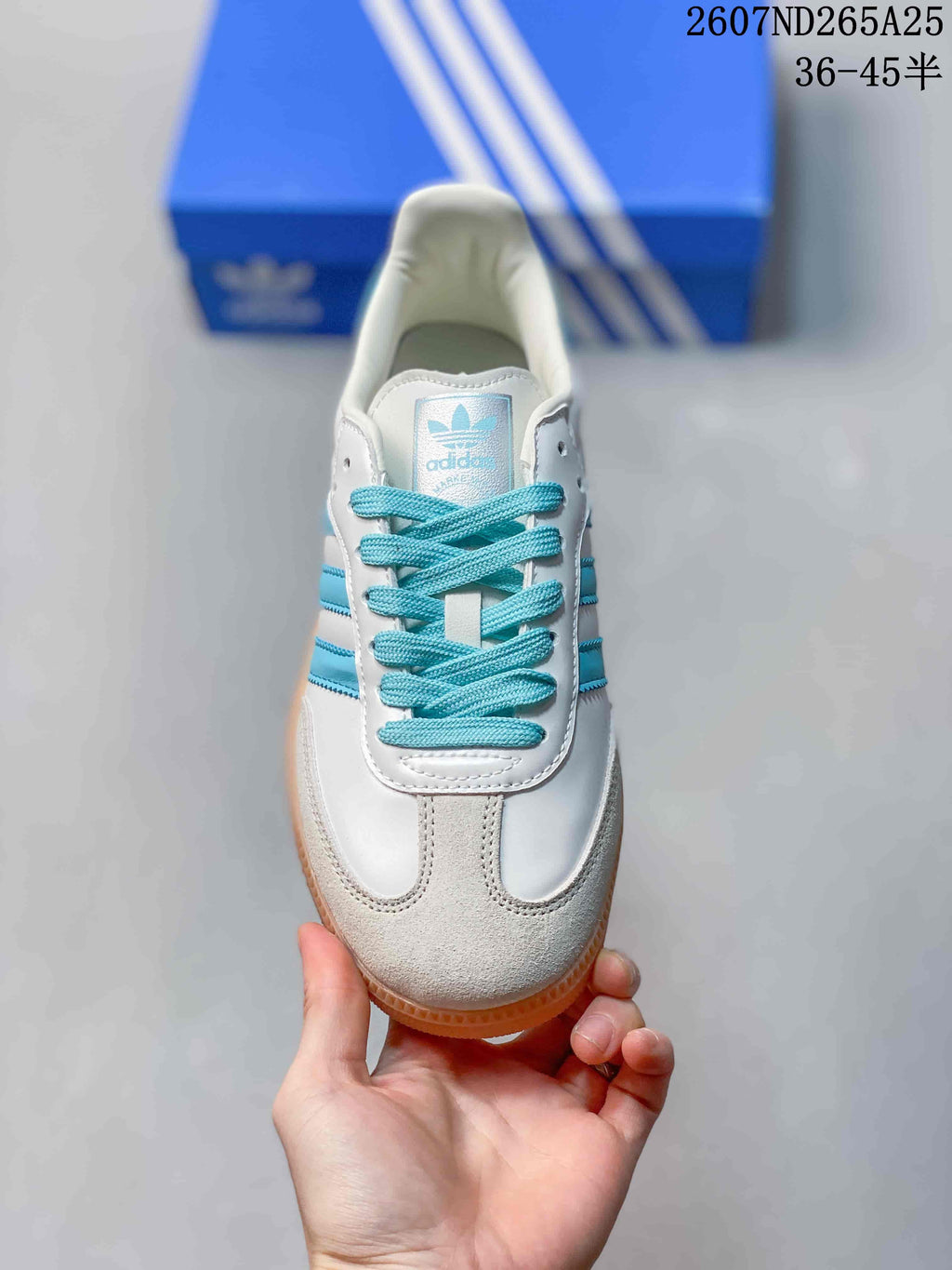 Top view showing the rounded toe, blue laces, stitched panels, and tongue label.