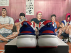 Rear view of white New Balance sneakers with red and navy accents and chunky soles.