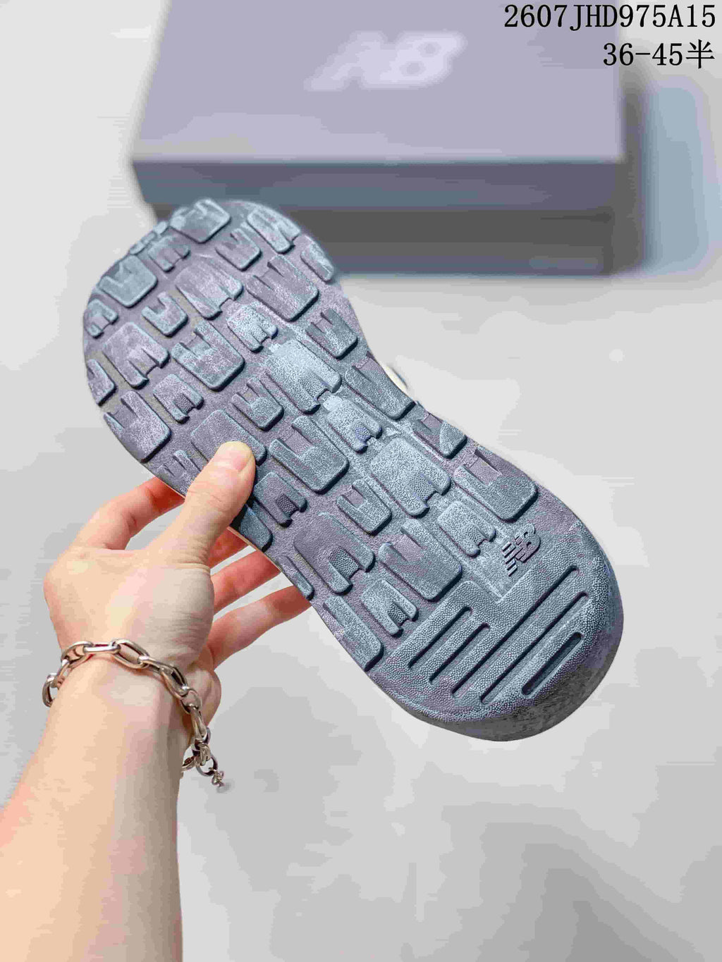 Close-up of the dark textured outsole and its segmented tread pattern.