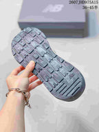 Close-up of the dark textured outsole and its segmented tread pattern.