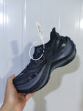 Black Balenciaga sneaker shown from the side with layered panels, mesh sections and a sculpted sole.