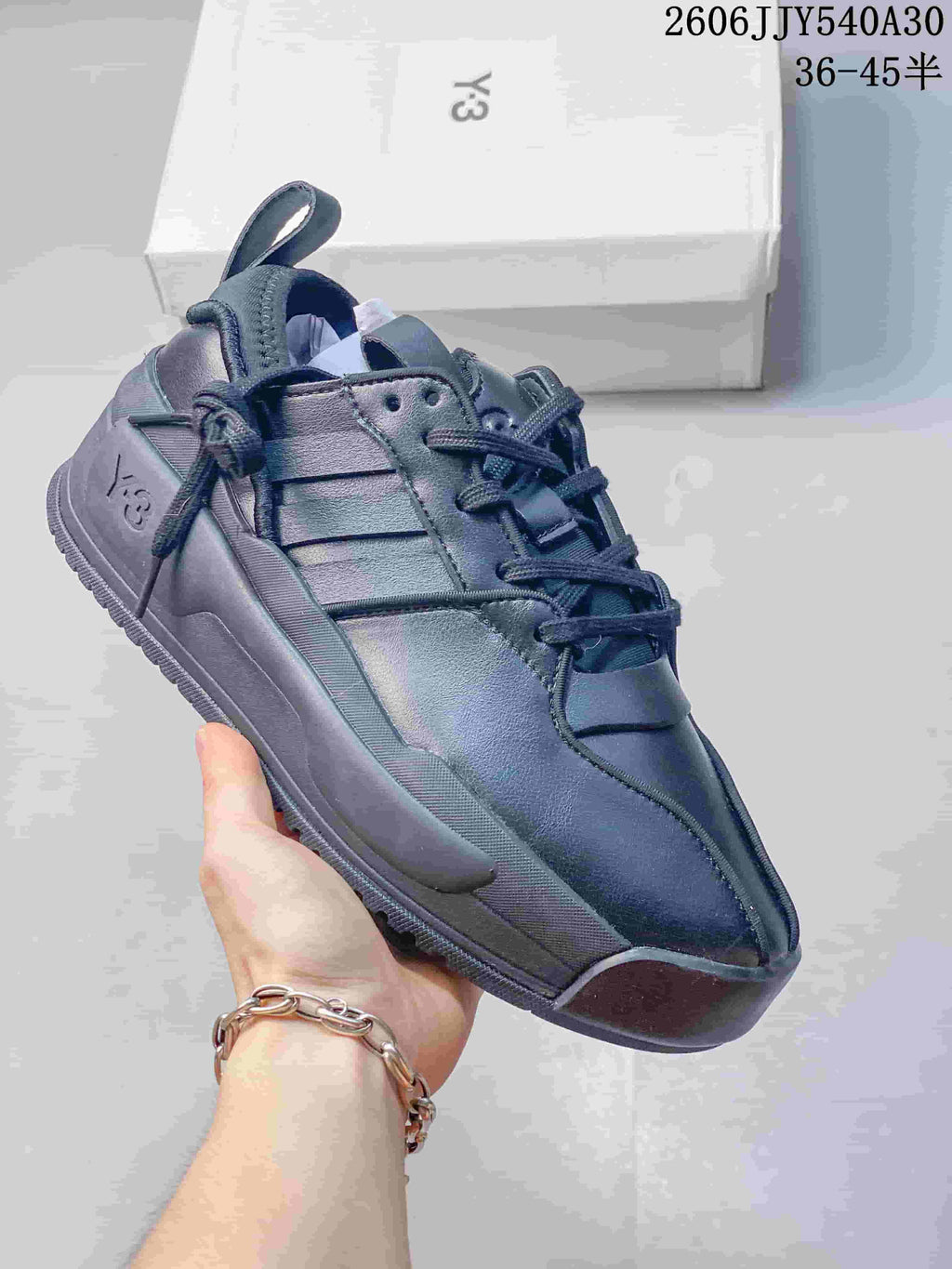 Dark monochrome Y-3 Rivalry sneaker with a sculpted sole and side logo detail.