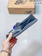 Side profile showing the low-top shape, layered panels, lace area, and slim gray sole.
