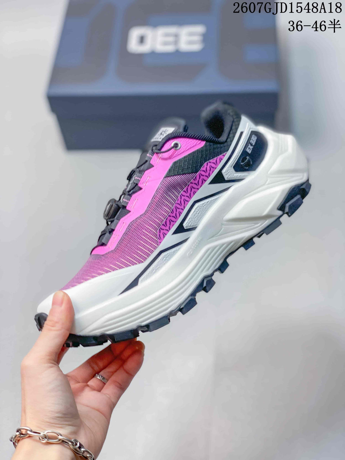Side view showing the pink textured upper, white midsole and black traction outsole.