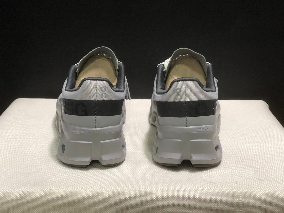 Rear view of the pair showing padded collars, dark heel bands, and structured white heel sections.