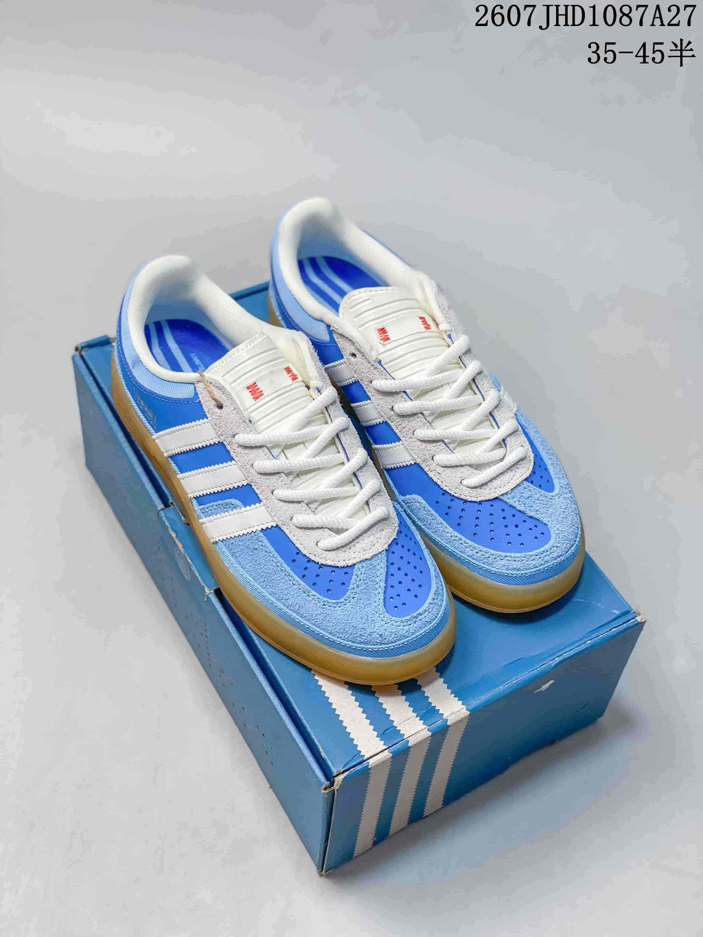 Blue and white adidas Samba ADV sneakers shown from above on a blue shoebox.