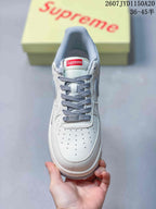 Top view of the sneaker showing the perforated white toe box, grey laces, tongue label, and grey collar lining.