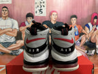 Rear view of grey and white Nike basketball shoes with red accents and black heel detailing