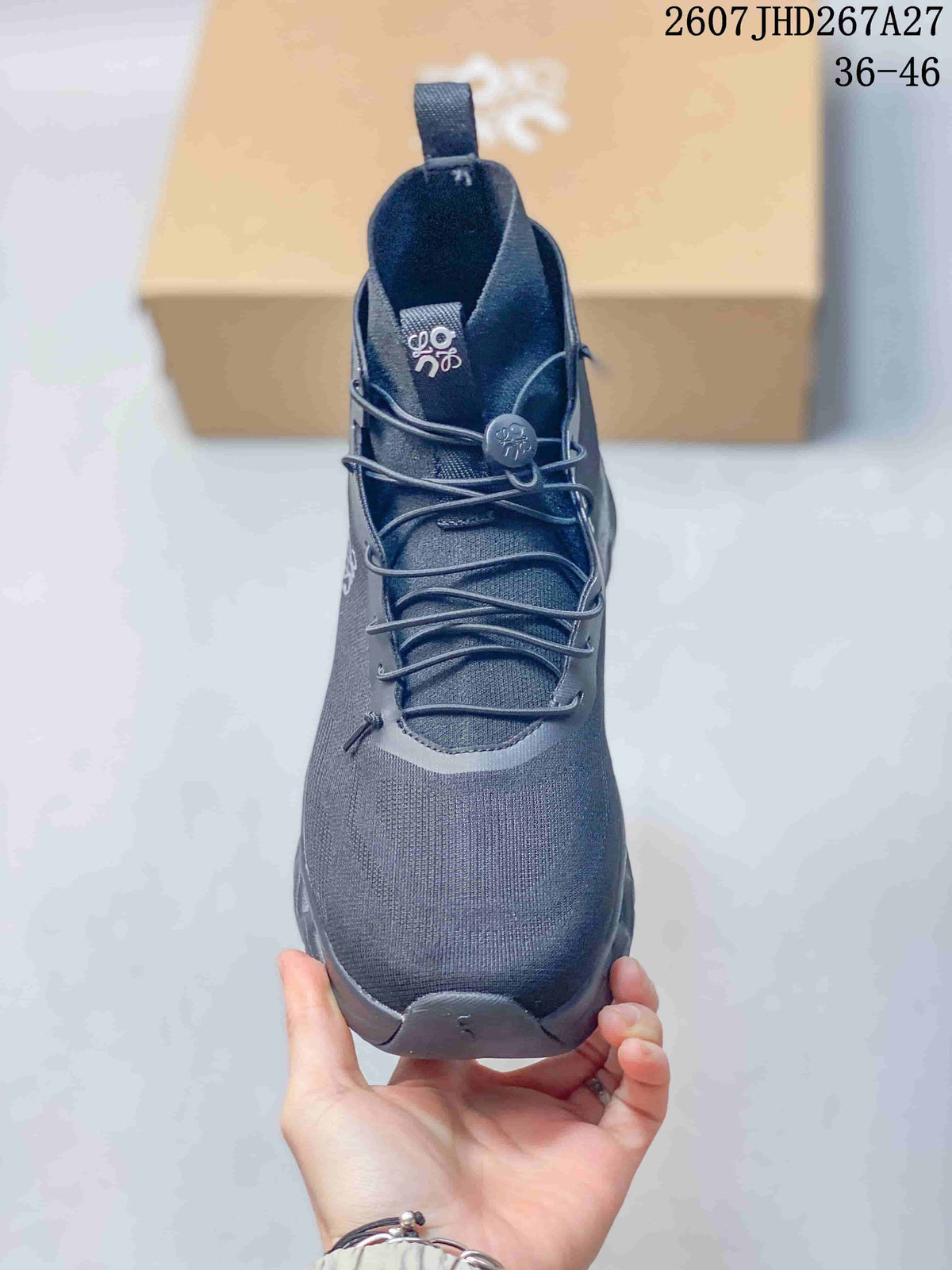 Front view of a dark gray high-top sneaker with a rounded toe, layered laces, toggle closure and pull tab.