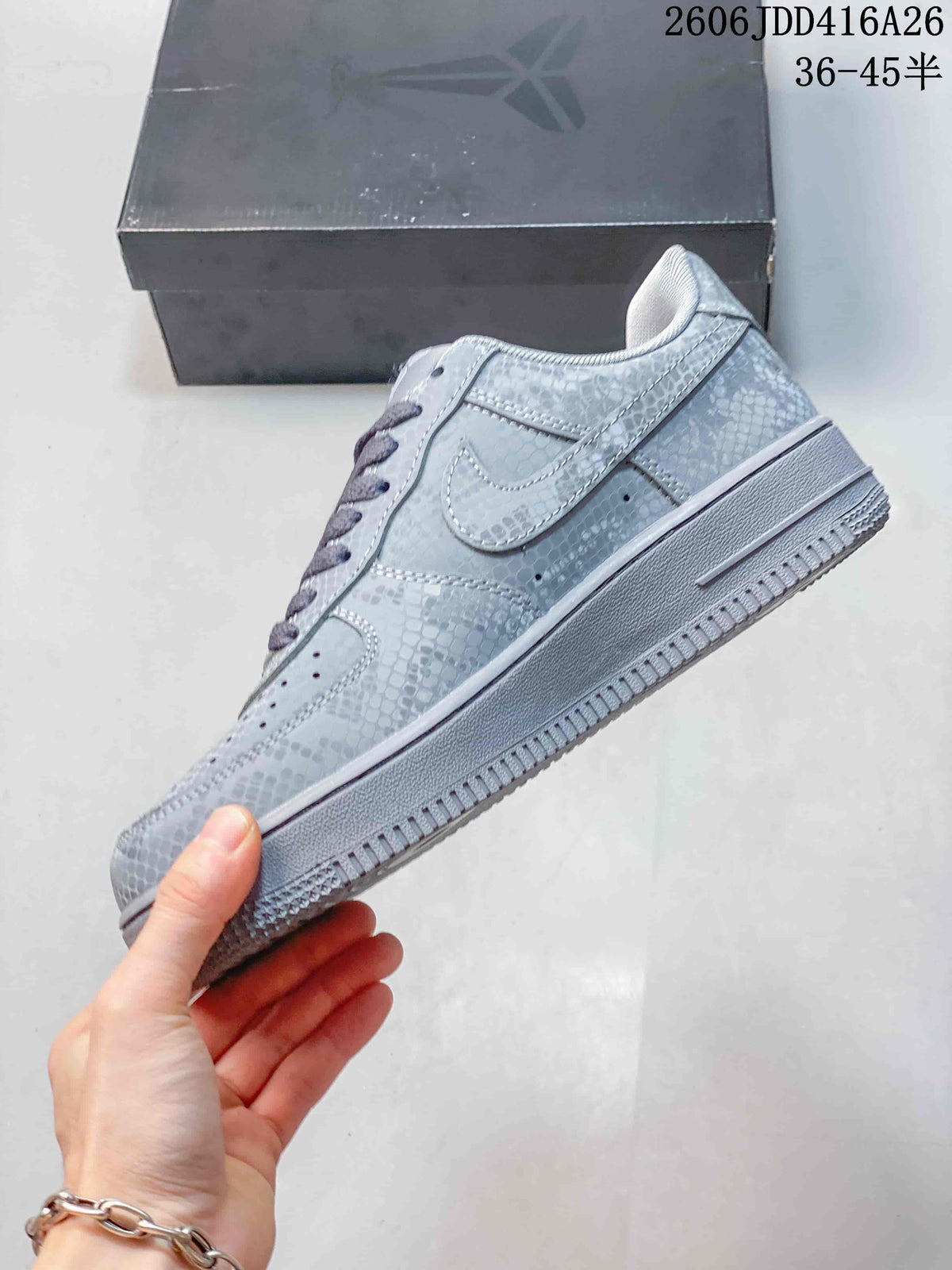 Side profile of a silver-gray patterned low-top sneaker