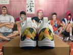 Rear view of white Mizuno Wave Momentum 3 shoes with multicolor patterned heel panels and dark blue outsoles.