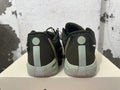 Rear view of black and gray low-top basketball shoes with light-colored heel details