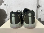 Rear view of black and gray low-top basketball shoes with light-colored heel details