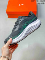 Side view of a charcoal Nike running shoe with green accents and a sculpted white midsole; image text shows 40–45.
