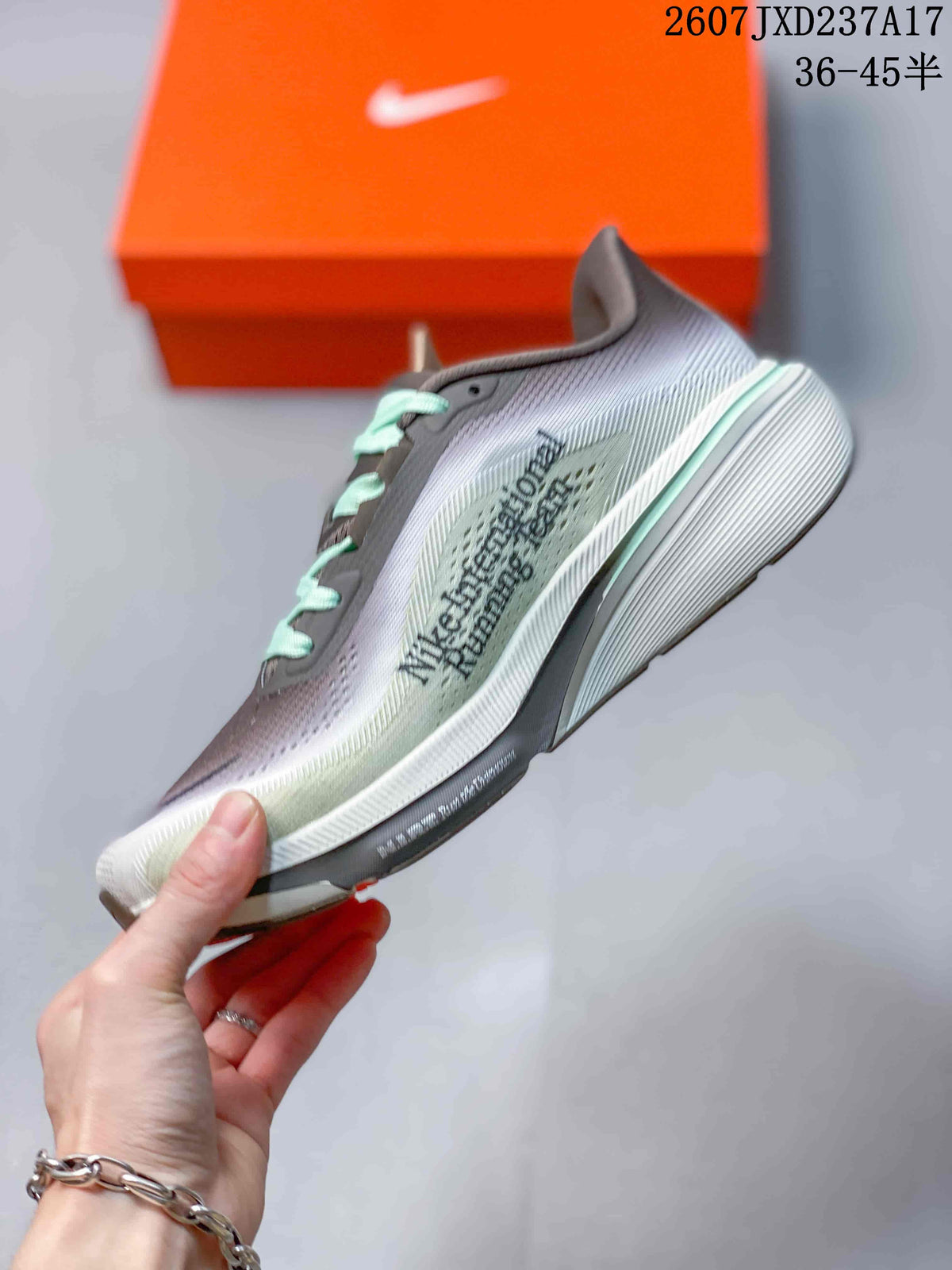 Side view of the gray running shoe showing the Nike Swoosh, layered upper and white midsole.