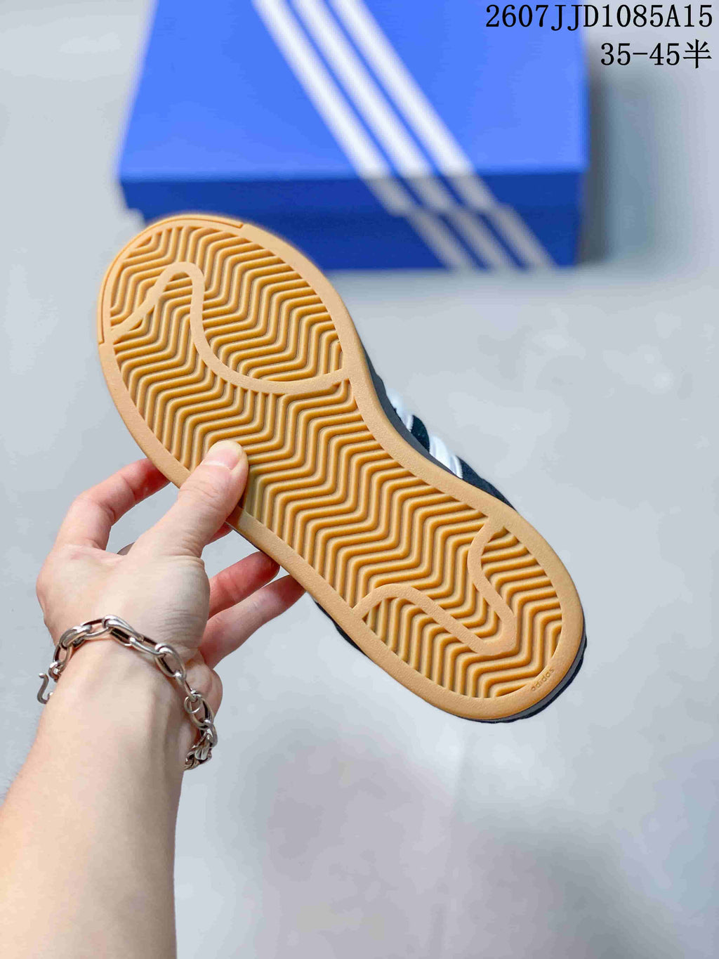 Close view of the gum-colored outsole with a repeating wavy tread pattern.