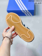 Close view of the gum-colored outsole with a repeating wavy tread pattern.