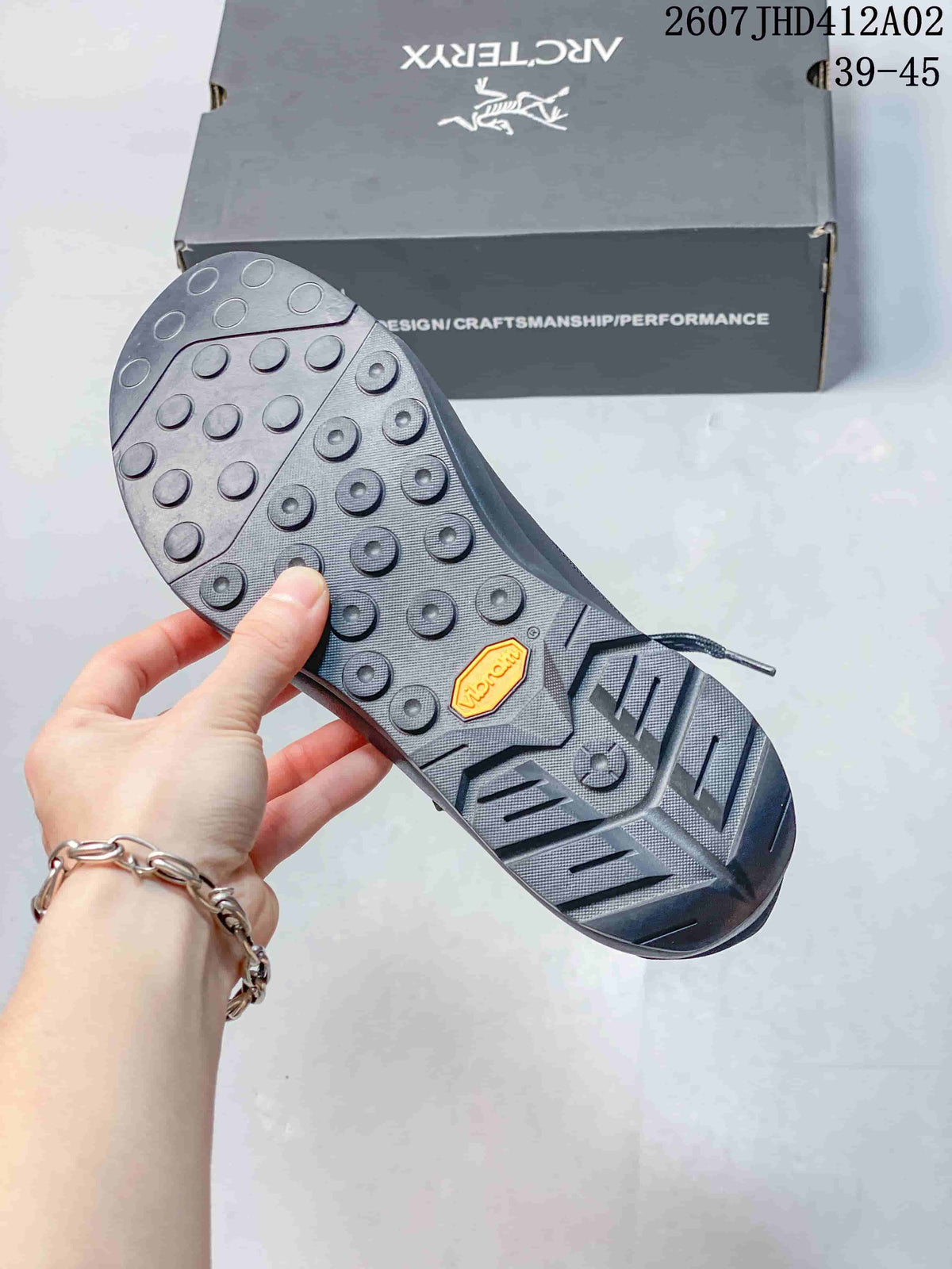 Close-up of the shoe outsole showing patterned tread and rounded lugs