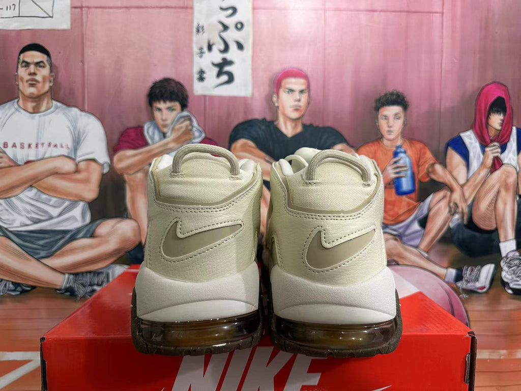 Rear view of cream Nike Air More Uptempo sneakers with Swoosh details and dark outsole accents.