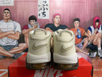 Rear view of cream Nike Air More Uptempo sneakers with Swoosh details and dark outsole accents.