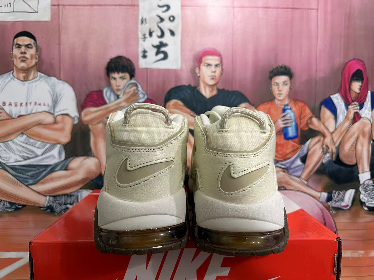 Rear view of cream Nike Air More Uptempo sneakers with Swoosh details and dark outsole accents.