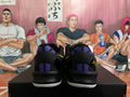 Rear view of black Nike basketball shoes with purple heel accents and white outsoles