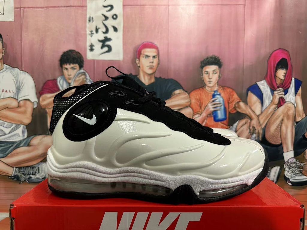 Side view of a white and black Nike sneaker showing the sculpted side and visible cushioning unit