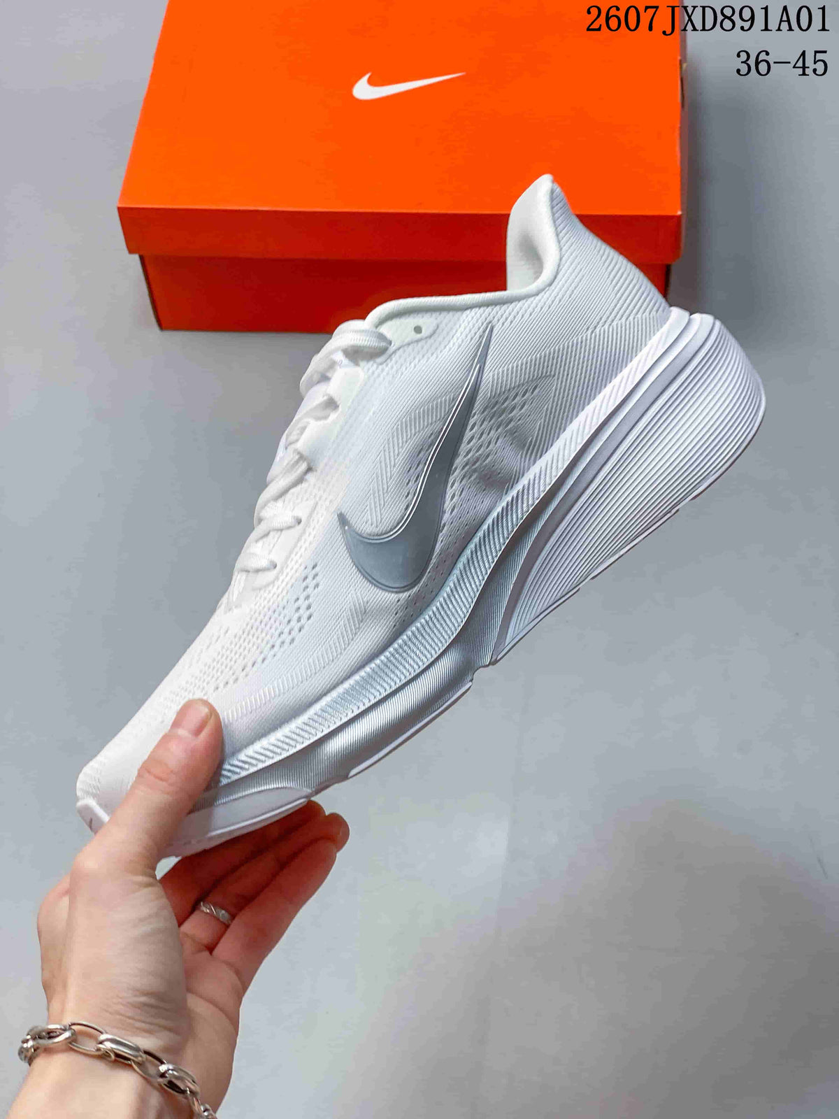 Side view of the white running shoe with silver-tone side logo