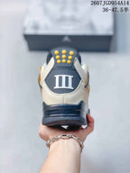 Rear view showing the dark heel panel, white Roman numeral detail, and gold hardware.