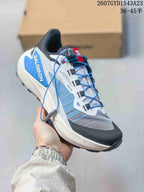 White and blue Salomon Genesis shoe with blue quick-lace cord and contrasting gray panels.