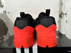Rear view of red and black Adidas Dame 9 basketball shoes