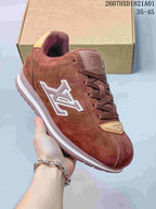 Close view of a reddish-brown sneaker showing its side emblem, laces and light-colored trim.