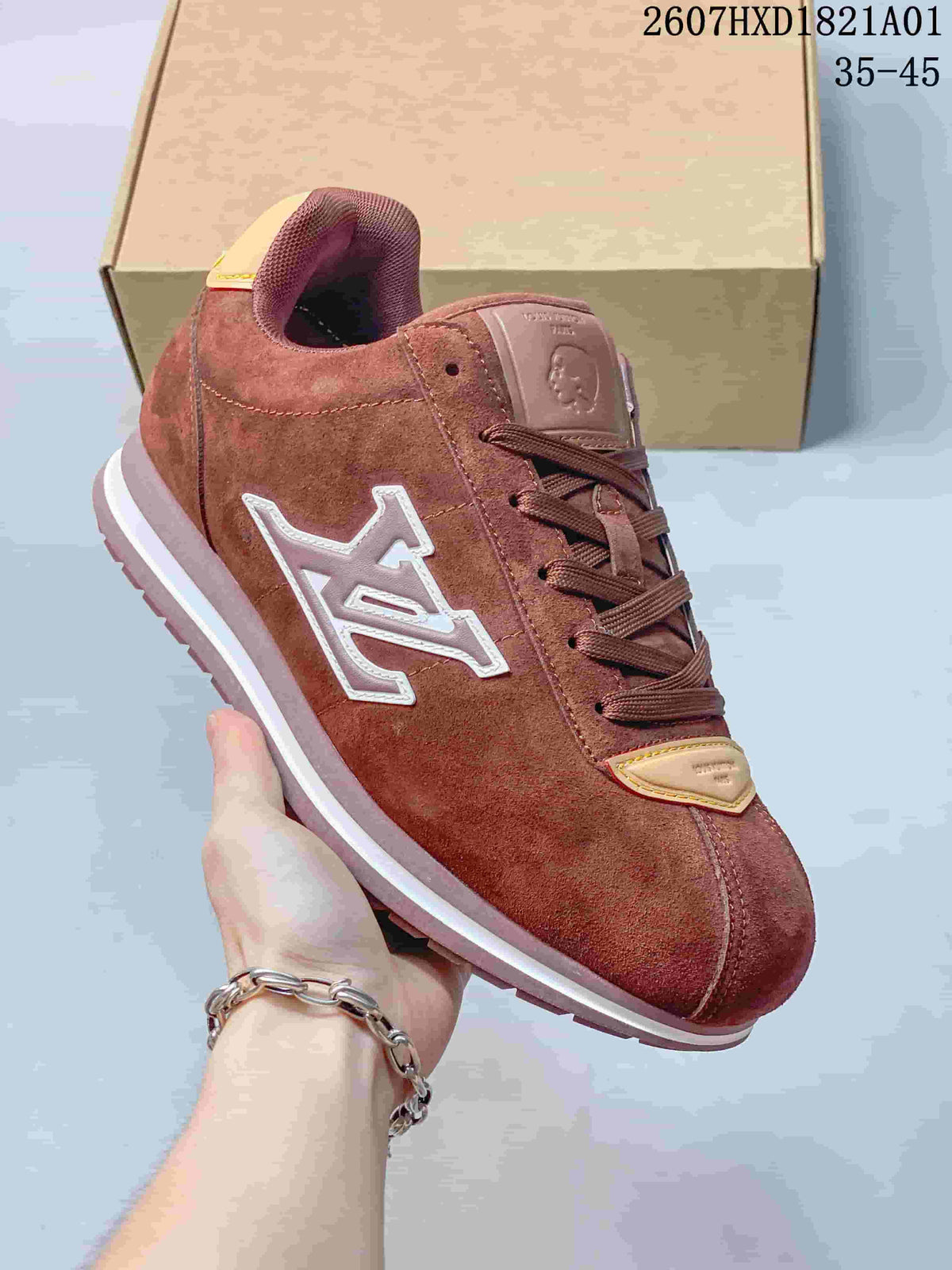 Close view of a reddish-brown sneaker showing its side emblem, laces and light-colored trim.