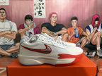 Side view of a white Nike basketball shoe with a red-outlined Swoosh and Zoom marking.