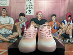 Front view of pink Nike basketball sneakers with matching laces and black tongue branding.