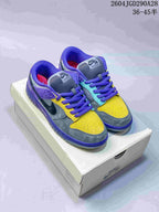 Pair of multicolor Nike Dunk Low SB-style sneakers on a shoebox