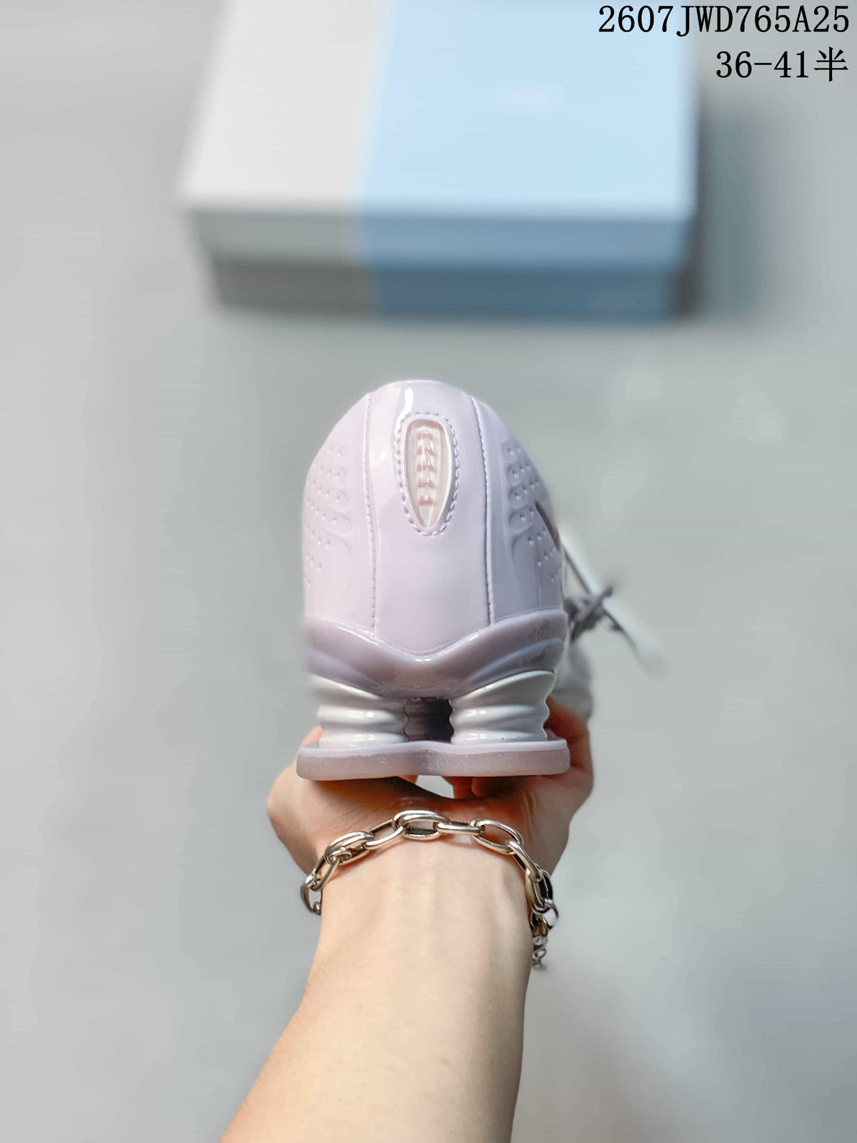 Rear view highlighting the sculpted heel and Shox-style heel elements.