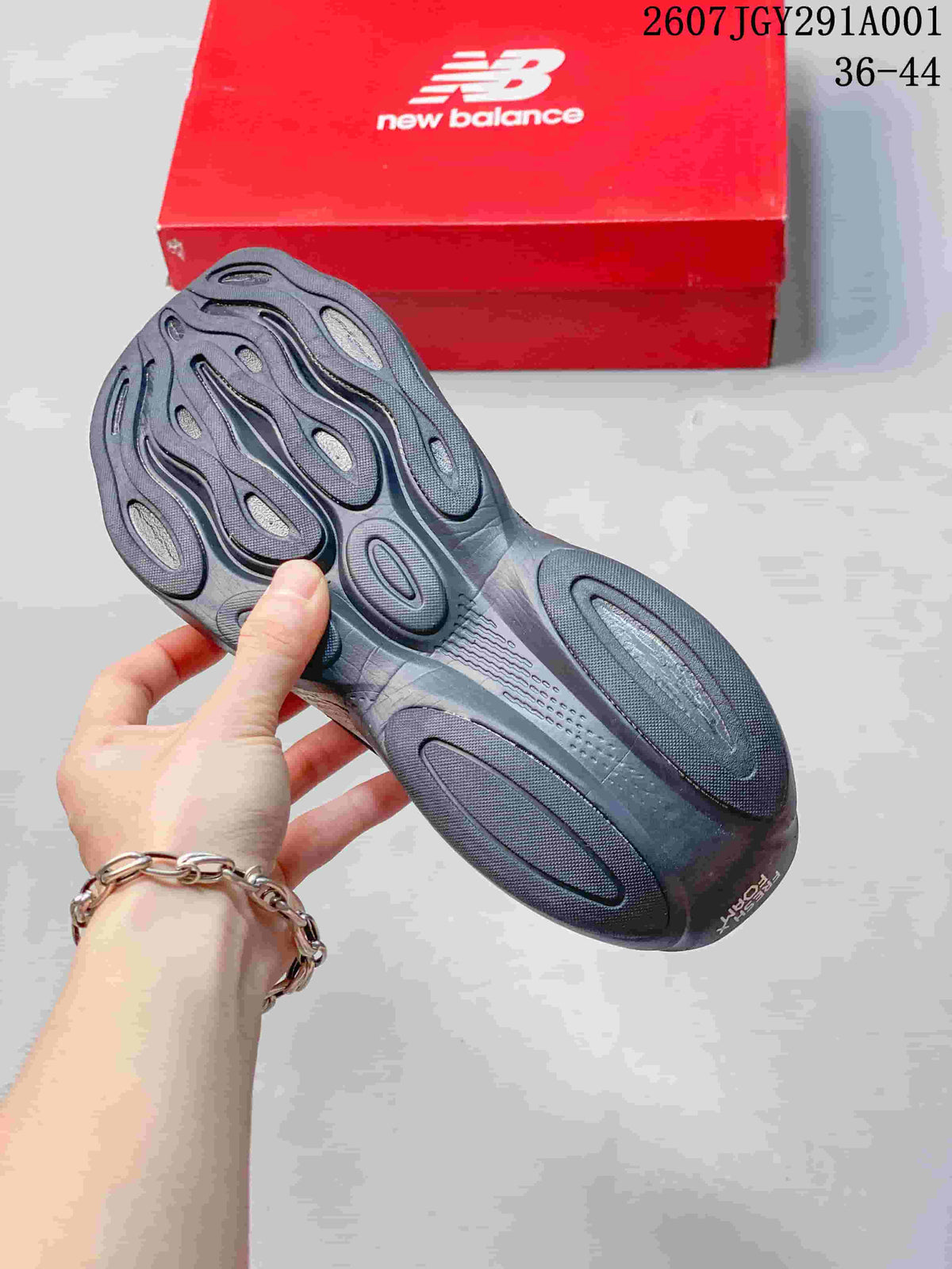 View of the shoe outsole showing its sculpted tread, with a red New Balance box in the background.