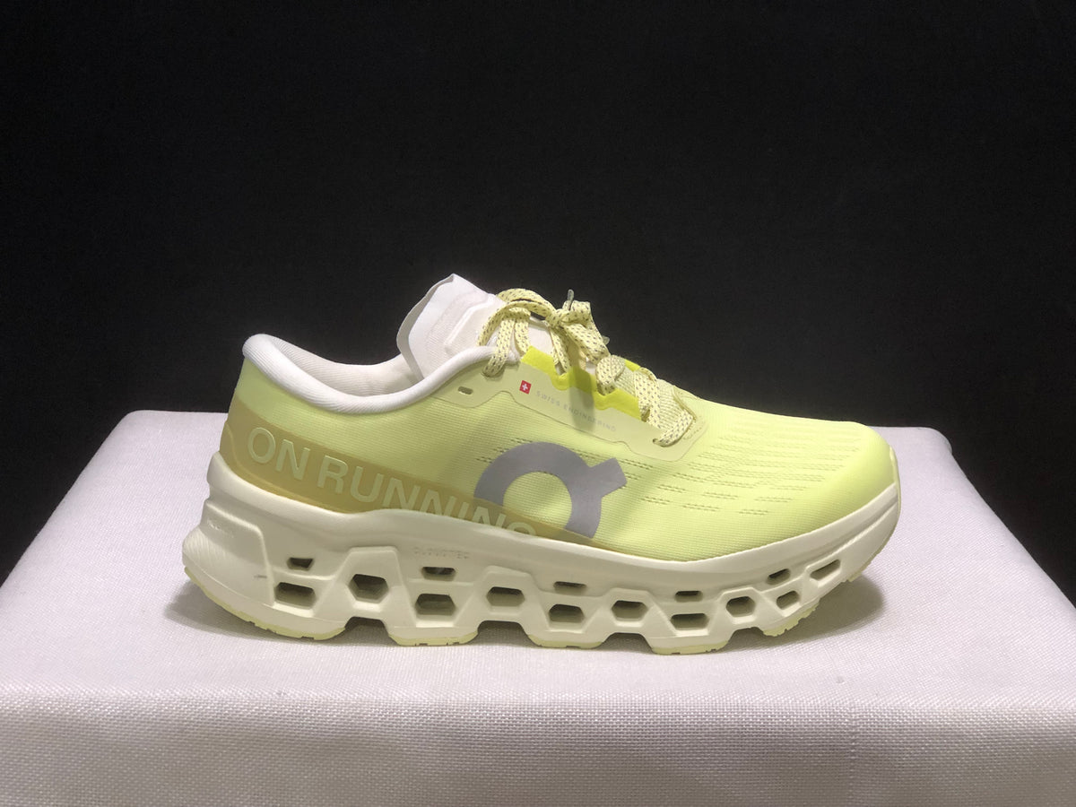 Side profile of a light yellow On Cloudmonster 3 sneaker with a white sculpted sole.