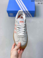 Top view of one sneaker showing white laces, textured tongue, and adidas label.