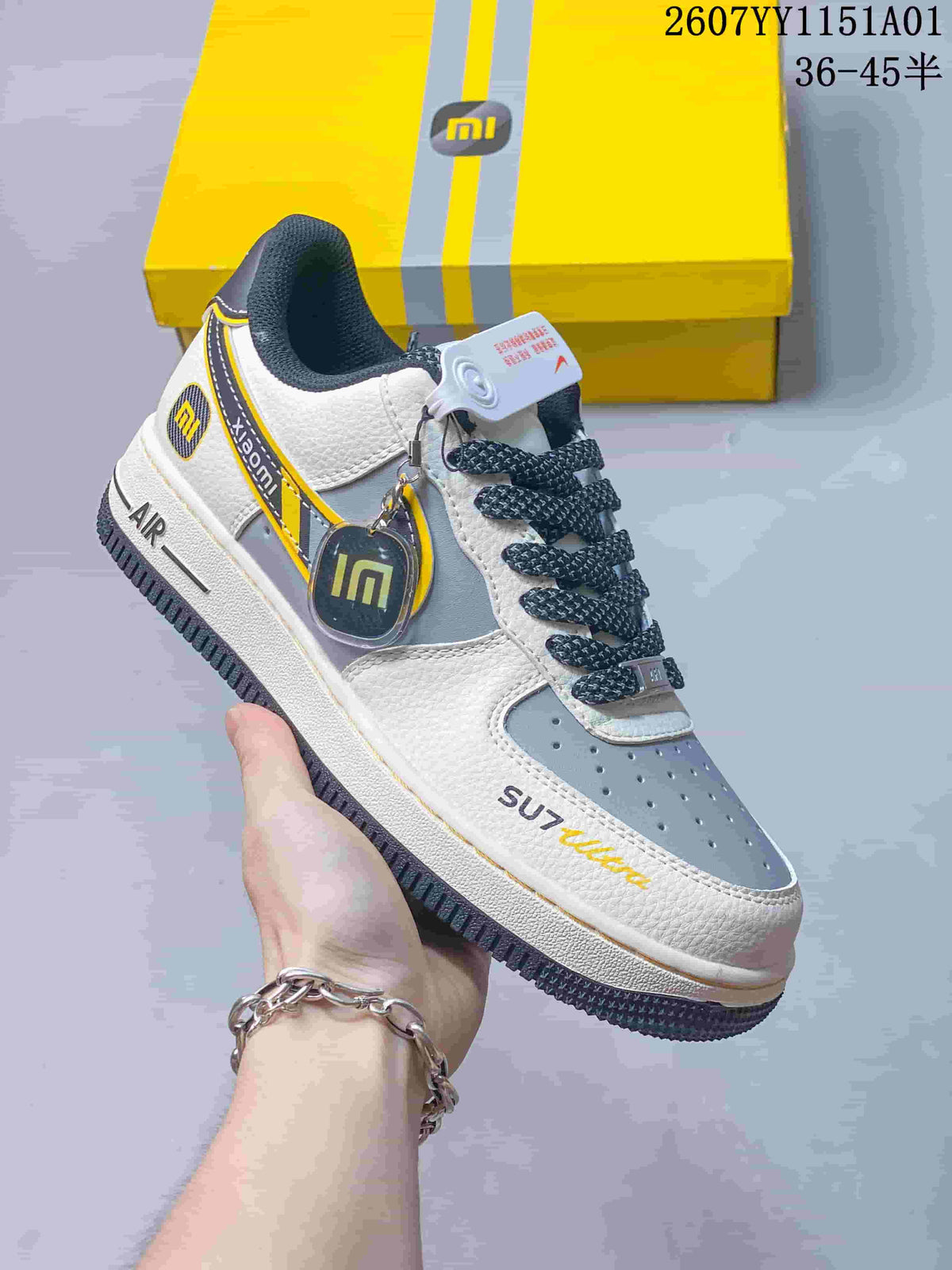 Angled view of the sneaker with SU7 Ultra lettering, Xiaomi-themed details, and yellow trim.