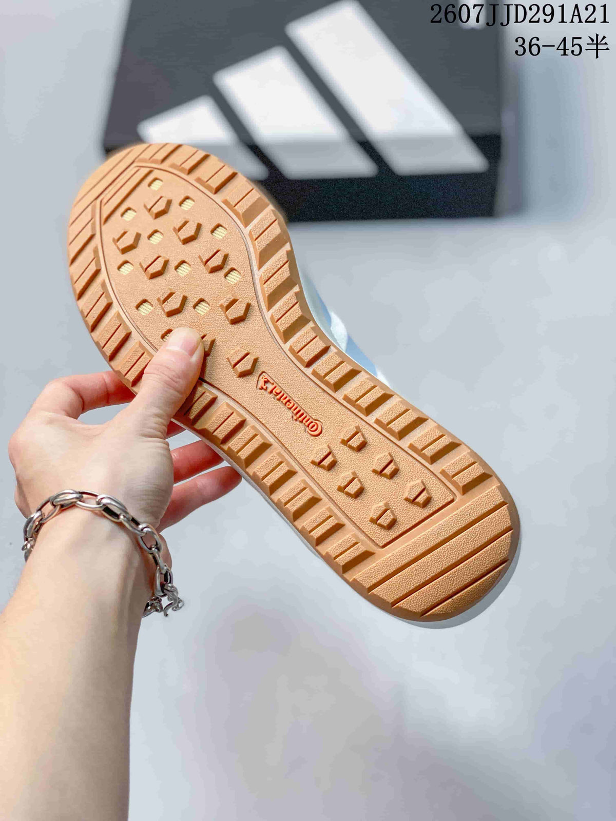 Close-up of the gum-colored outsole showing its raised tread pattern and central adidas branding.