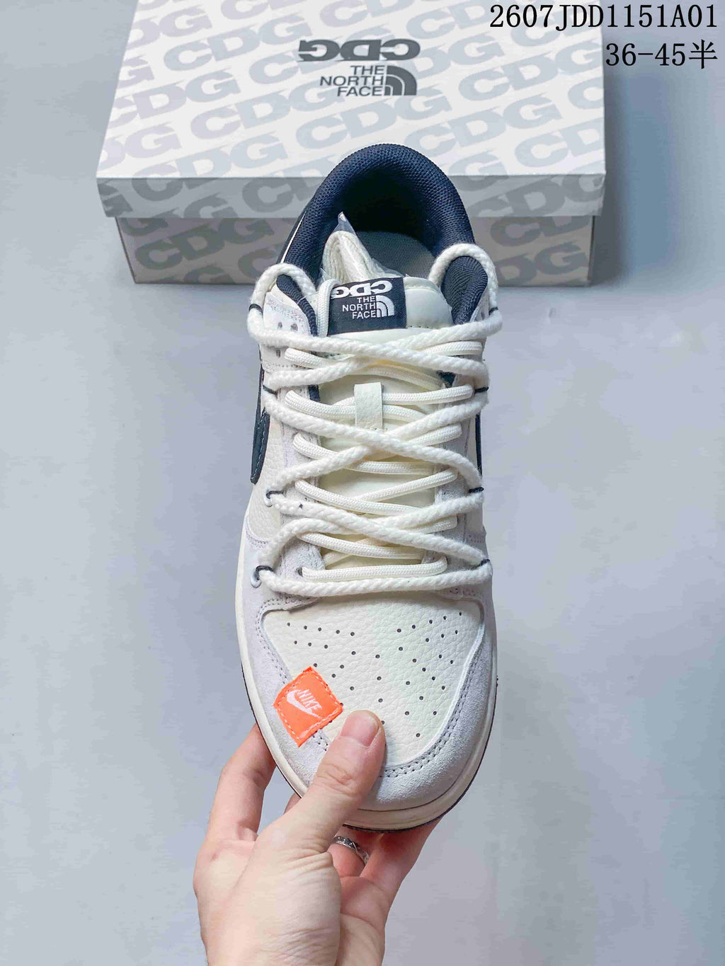Top view showing white laces, a perforated toe, and orange accent