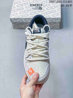 Top view showing white laces, a perforated toe, and orange accent
