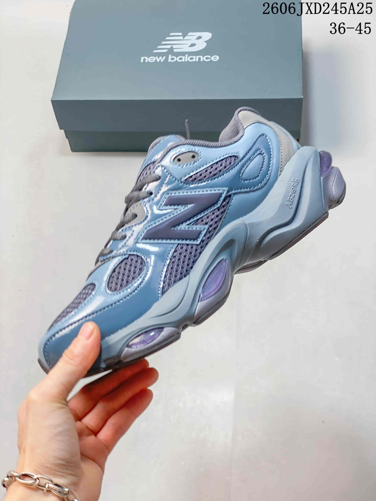 Side view of a blue and gray sneaker with mesh panels and purple accents