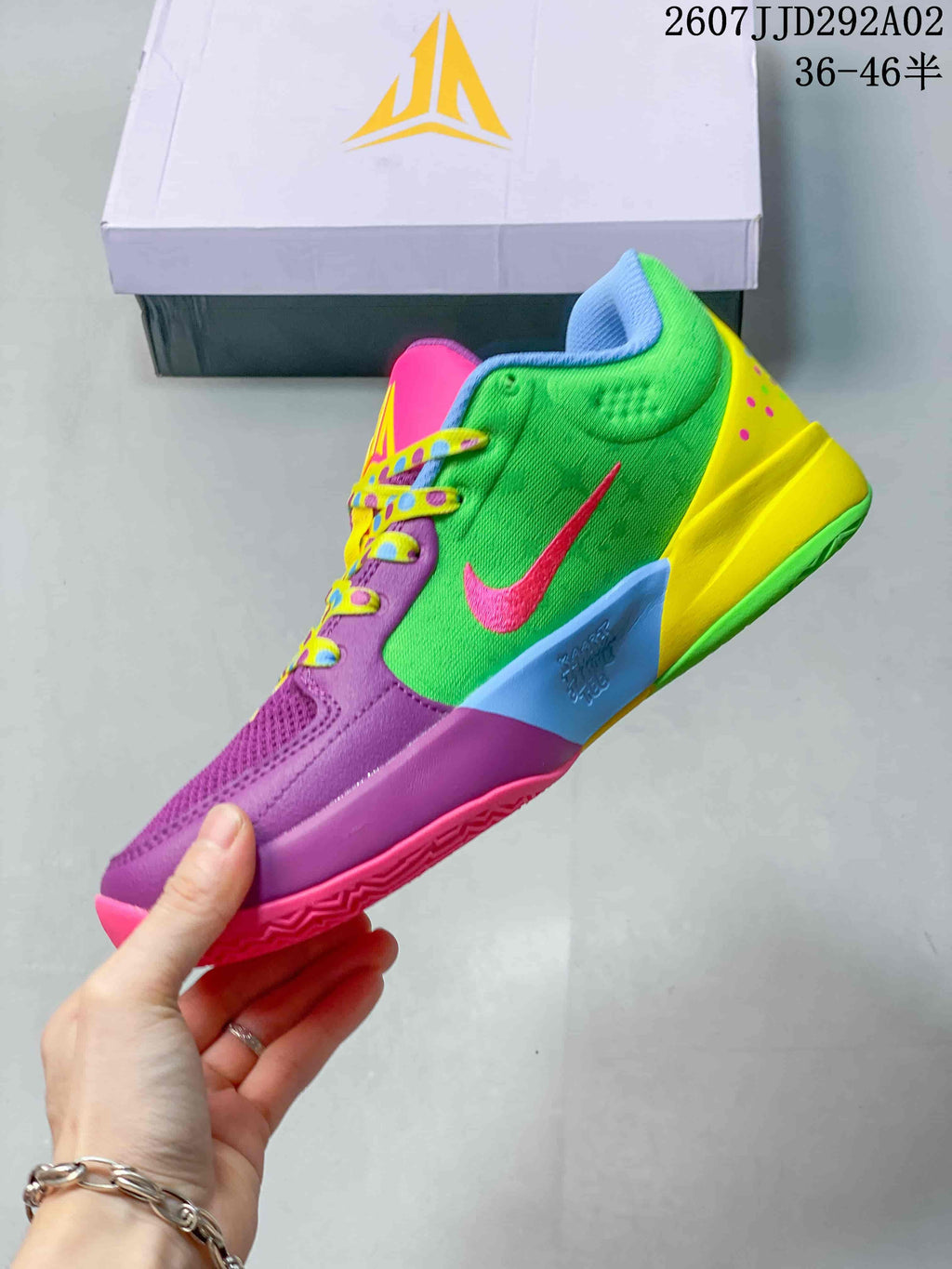 Side profile of the multicolor basketball shoe showing the green upper, pink swoosh, purple forefoot and yellow heel.