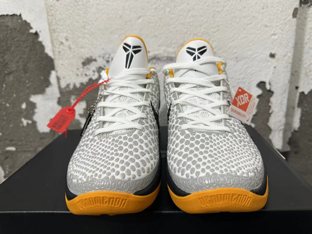 Front view showing the patterned uppers, white laces, and yellow outsoles